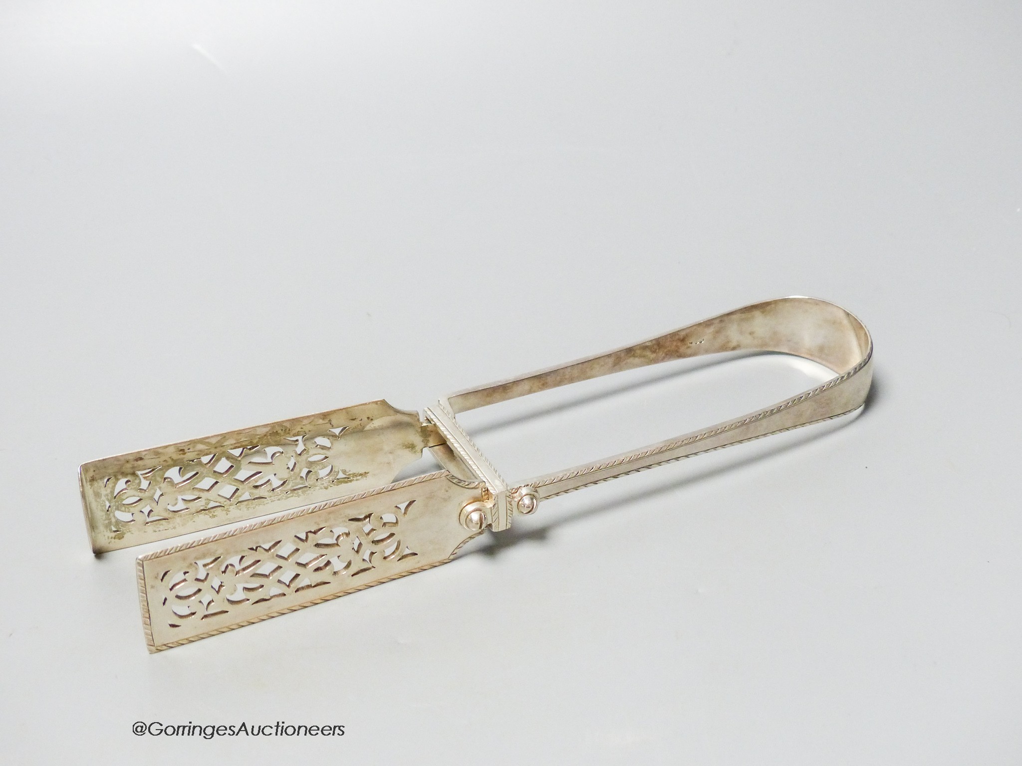 A pair of Victorian silver engraved feather edge asparagus tongs, by George Adams, London, 1869, 25.1cm, 6.5oz.